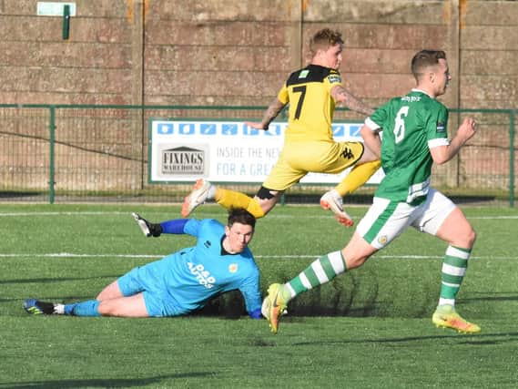 Callum Saunders leaps over the keeper to score in the first game. Picture by Grahame Lehkyj