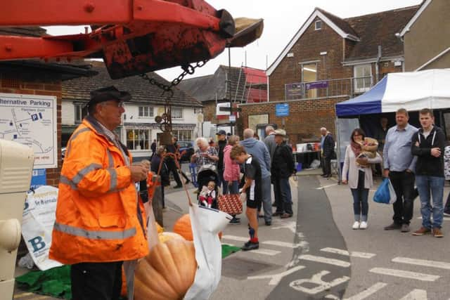 Weighing the pumpkins at Steyning Farmers Market on Saturday