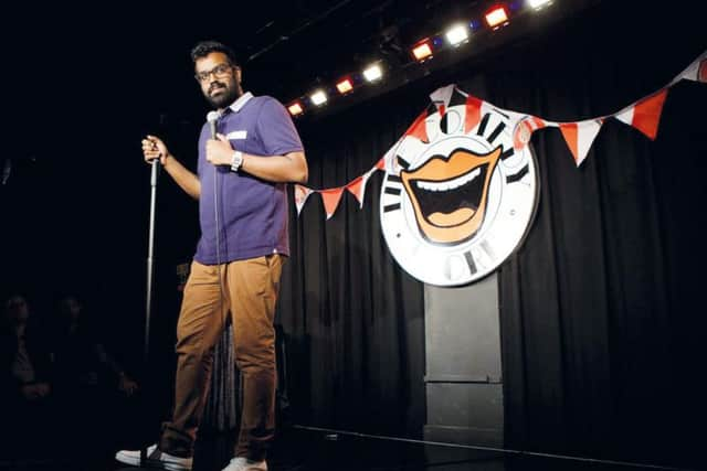 Romesh Ranganathan on stage at a gig