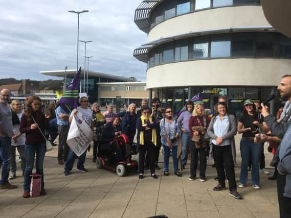 Campaigners gather outside the walk-in centre SUS-181015-115422001