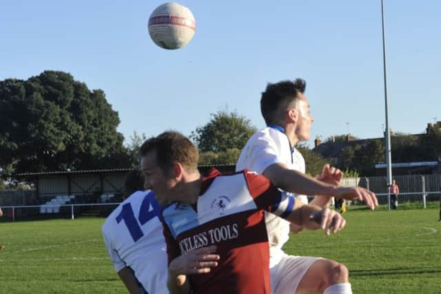 Two-goal Little Common forward Lewis Hole goes up for a header