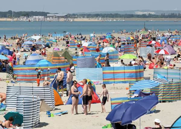 DM17629176a.jpg Sunseekers, parasols and windbreaks on West Wittering Beach, 17th June 2017. Photo by Derek Martin SUS-170617-194748008