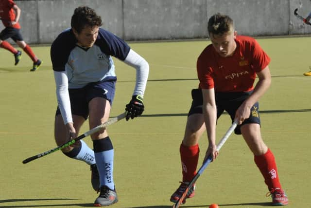 Nick Taylor keeps a close eye on the Mid Sussex player in possession