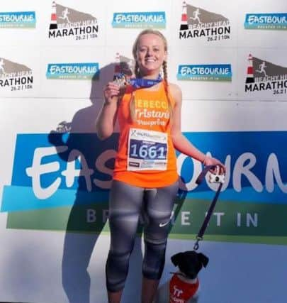 Rebecca after running Beachy Head Marathon, photographed with Bella the dog