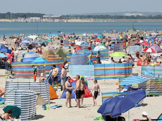 DM17629176a.jpg Sunseekers, parasols and windbreaks on West Wittering Beach, 17th June 2017. Photo by Derek Martin SUS-170617-194748008