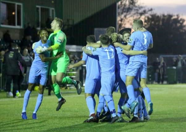 Tyrell-Richardson Brown and goalkeeper Josh Pelling celebrate the winger's late winner against Ashord United. Picture by John Lines