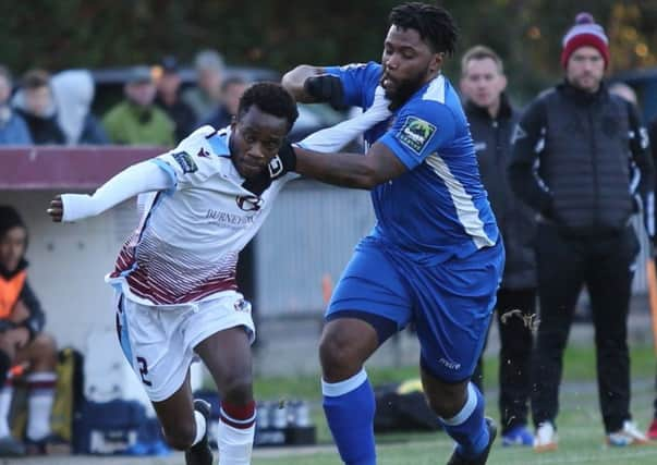 Hastings United (all white kit - Emmanuel Mensah) v Three Bridges (all blue kit - Omar Folkes) football action SUS-180411-210918002