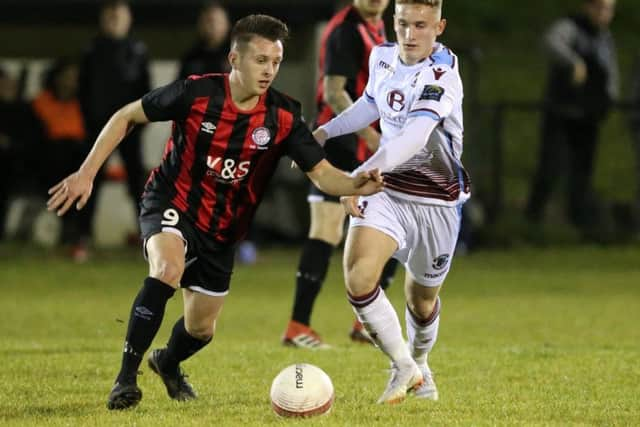 Adam Lovatt closes down a Saltdean United opponent