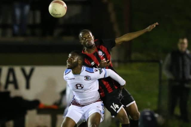 Hassan Ibrahim competes for an aerial ball