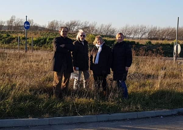 Campaigners from Community Action Newhaven standing by the roundabout they say will be ripped up