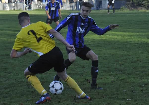 Hollington United's match-winner Kian Moynes goes in for a tackle against Burgess Hill Town. Pictures by Simon Newstead