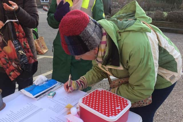 A supporter signs the letter to West Sussex County Council