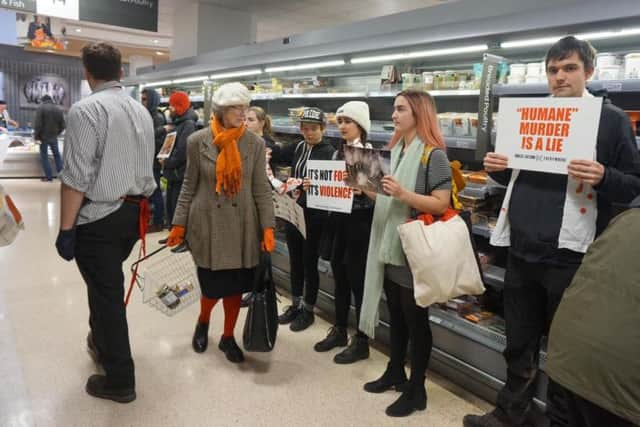 Vegan activists at the meat aisle in Waitrose, Brighton (Photographs: Direct Action Everywhere)