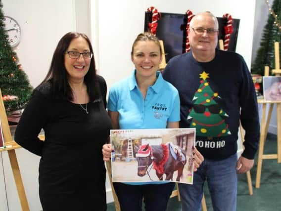 Patients Tania House and David Devonport with Joanne Moxon from Paws Pantry and the winning picture