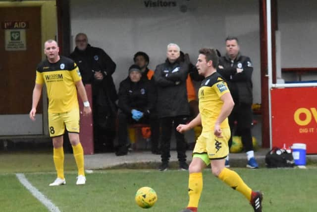 Karly Akehurst brings the ball out of defence against Hythe Town as Shaun Saunders watches on. Picture by Grahame Lehkyj