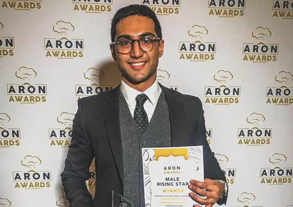 Thanbir Moktadir, owner of Horsham Tandoori, with his ARON award SUS-190121-154718001