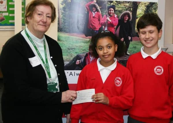 Reverend Renie Durnell (left) receives a cheque for ?122.25 from King Offa Primary Academy for the Bexhill Foodbank SUS-190122-094209001