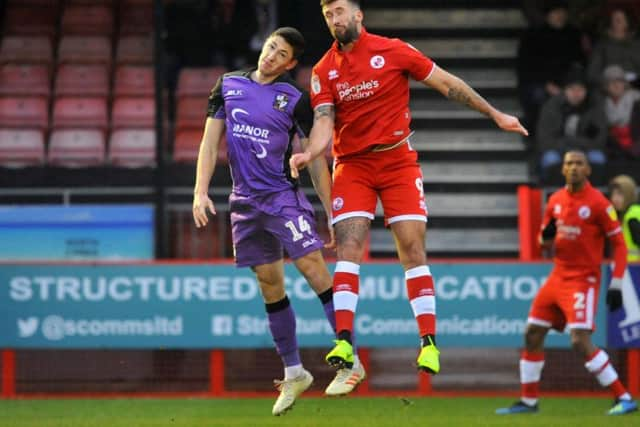 Ollie Palmer winning an aerial battle against Port Vale. Picture by Steve Robards