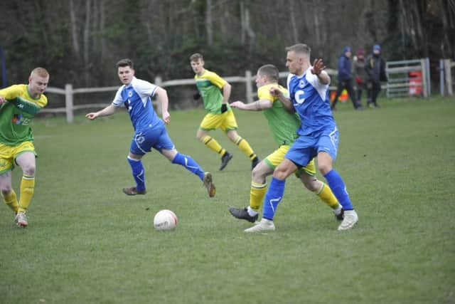 Westfield (yellow and green kit - Joe Dicken left, Jacob Shelton centre) v Roffey (blue and white kit) football action SUS-190120-112112002