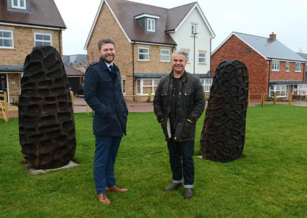 Bellways Daniel Storey with sculptor Walter Bailey at Solomons Seal development in Broadbridge Heath, alongside the sculptures which have been inspired by the seeds of the purple foxglove plant which is native to the area SUS-190122-102832001