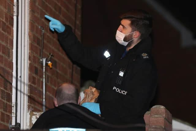 Police officers collecting evidence at the scene of the stabbings in Manning Road, Littlehampton