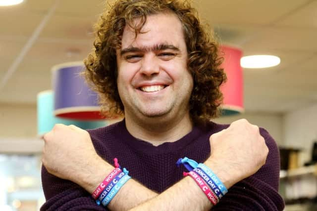 Daniel Wakeford wearing World Cancer Day unity bands