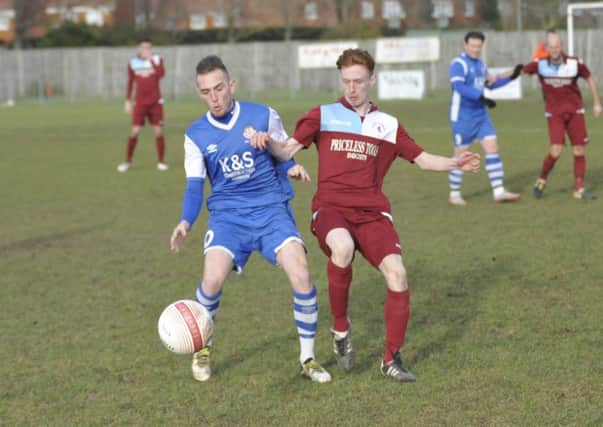 Little Common full-back Ollie Weeks keeps a close eye on Saltdean United forward Ryan Warwick