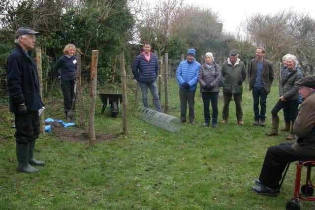 Roger Brown, left, a Steyning Community Orchard steering group member and expert on fruit trees, talks to supporters before the tree planting