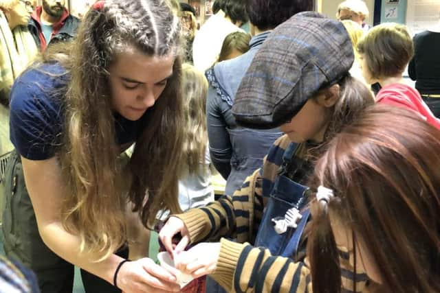 Madeleine Downie, 15 (Volunteer) helping Hunny Ryman, 8 and Billie Wildmay, 9 to extract DNA from a mashed banana