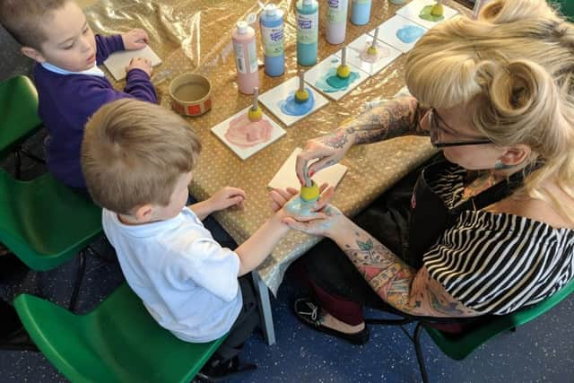 Each child has their hand painted and printed onto a tile