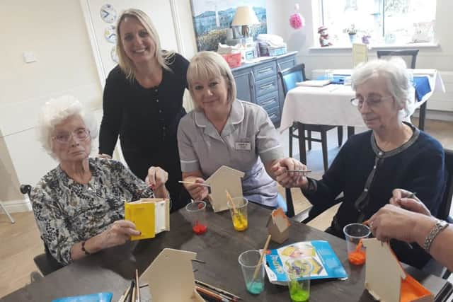 Kathleen Tapp, Caroline Thomas, Joanne Lane and Coral Cole painting birdboxes for the RSPB Big Garden Birdwatch