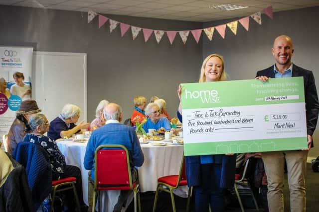 Mark Neal, managing director at Homewise, presents the cheque to Emily Kenward, founder of Time to Talk Befriending, at the February tea party