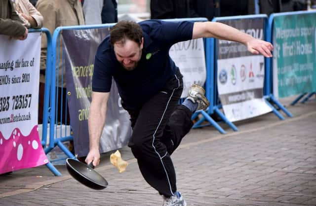 Pancake Race in aid of St Wilfrid's Hospice, Terminus Road, Eastbourne. SUS-170228-175300001