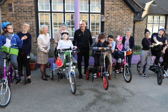 The staff with some of the children who benefit from the charity