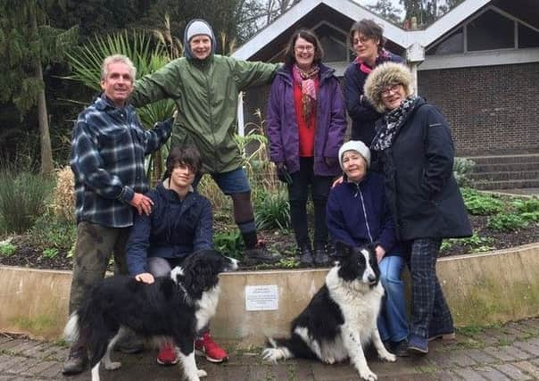 Alexandra Park Greenhouse Group volunteers and the commemorative plaque. SUS-190326-124932001