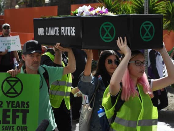 Extinction Rebellion activists in California carried a coffin to call for action on climate change - as Brighton activists will this Sunday (Photo by Mark RALSTON / AFP/Getty Images)