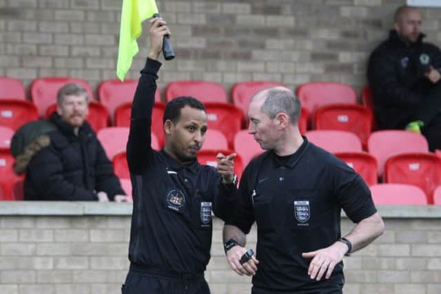 Horsham v Ashford United. The refeere consults his assistant and they wrongly rule out the goal. Picture by John Lines