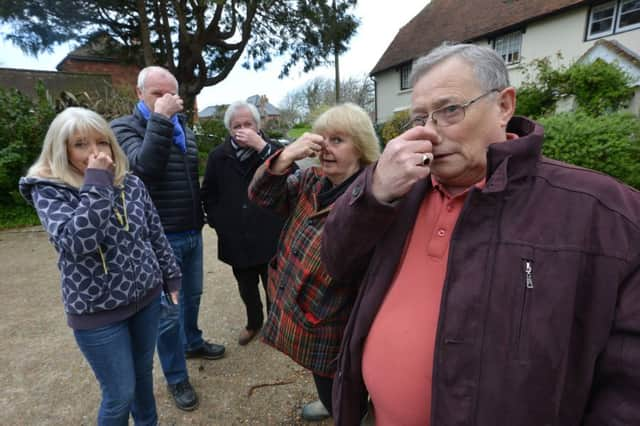 Pooh ... Bill Pierce (right) and neighbours hold their noses