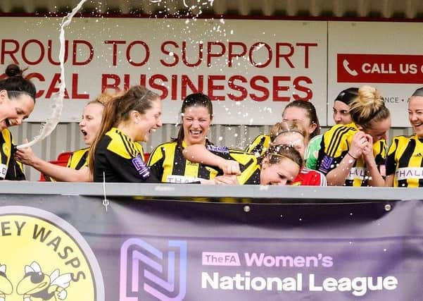 Crawley Wasps v Enfield Champagne: Wasps players pop the corks in celebration to mark back-to-back promotions. Picture by Ben Davidson www.bendavidsonphotography.com SUS-190416-102633002