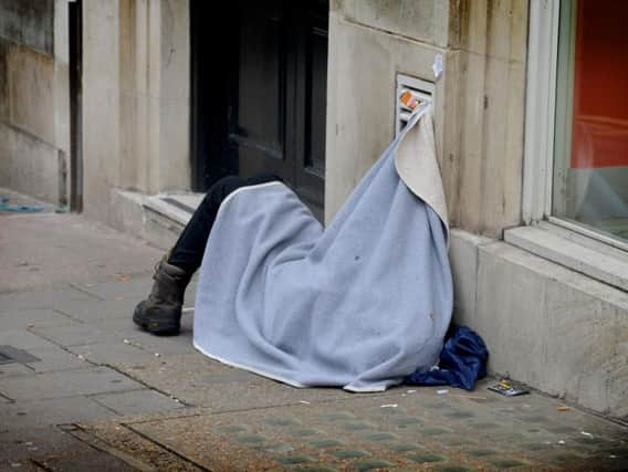 A person sleeping on the street.