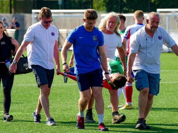 Brad Lethbridge is taken off on a stretcher at Dorking / Picture by Tommy McMillan