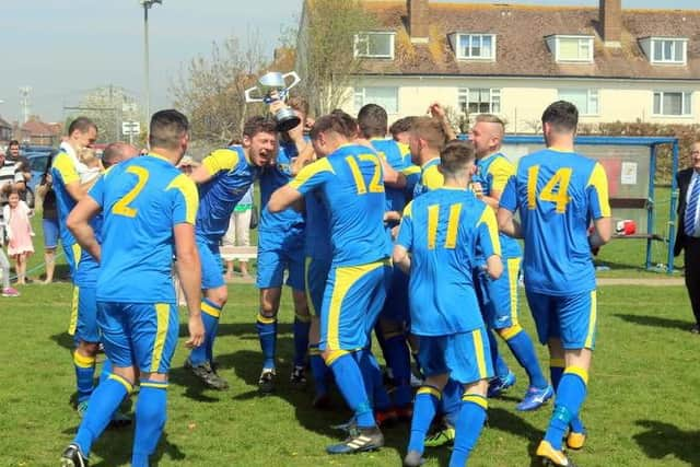 Rustington celebrate their league triumph.