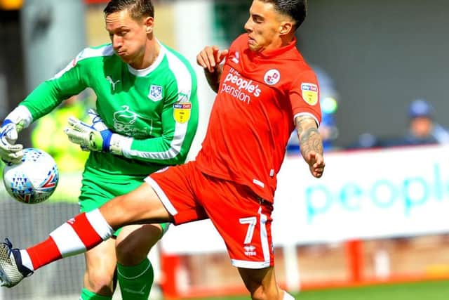 Crawley Town player Reece Grego-Cox challenges Tranmere Rovers goalkeeper Scott Davies. Picture by Steve Robards.