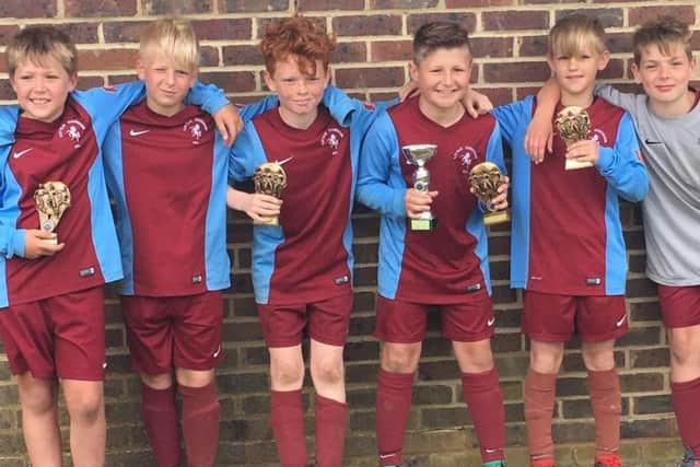 The Little Common Football Club under-10s team with its trophies