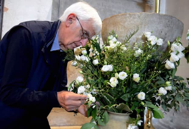 ks190335-8 Petworth Carpet of Flowers   phot kate
Andrew Howard with his display by the font, he is one of the men who created floral displays in the church.ks190335-8 SUS-190618-181326008