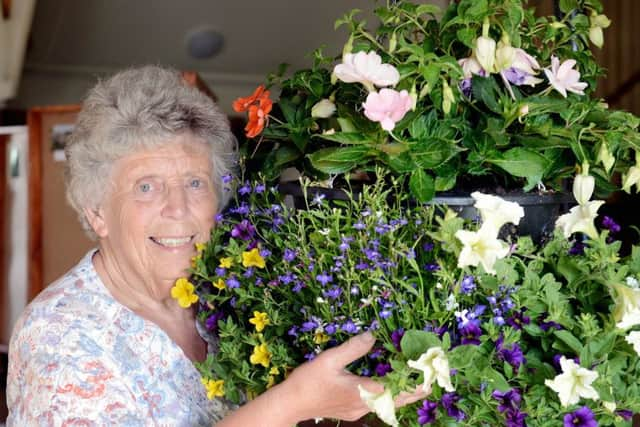 Anne Hllis with her hanging basket. Picture: Kate Shemilt ks190390-3