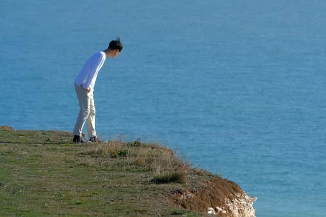 Tourists on Birling Gap cliff edge, photo by Peter Cripps