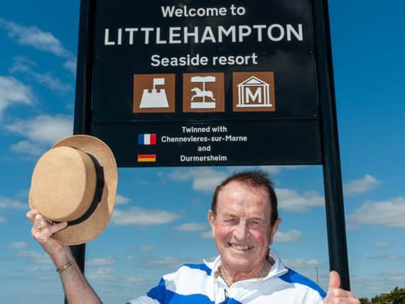 Councillor James Walsh with one of the new signs