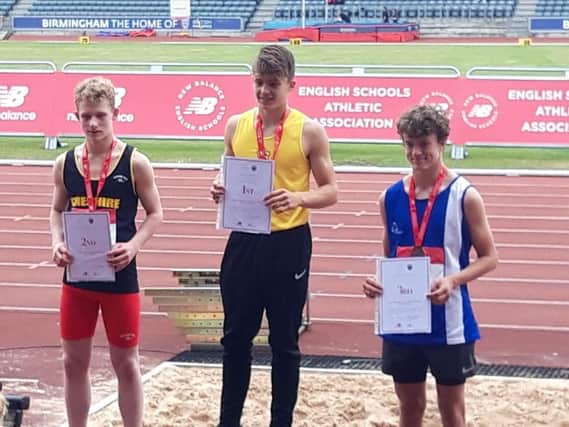 Bailey Smith (centre) on top of the podium at the English Schools Championships