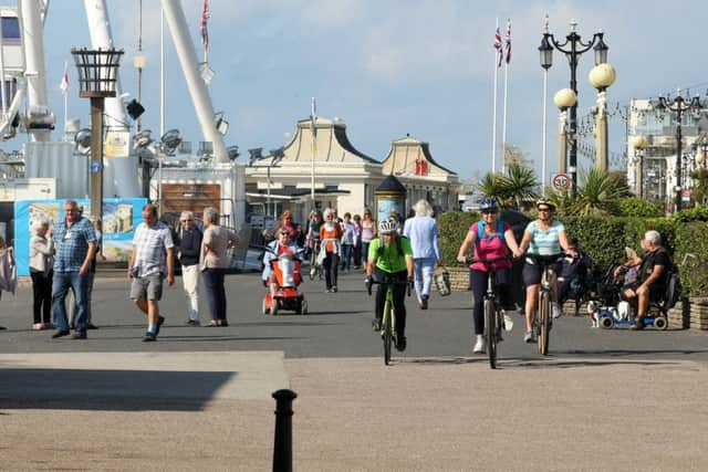 Members of the public using Worthing's promenade SUS-191009-142605001